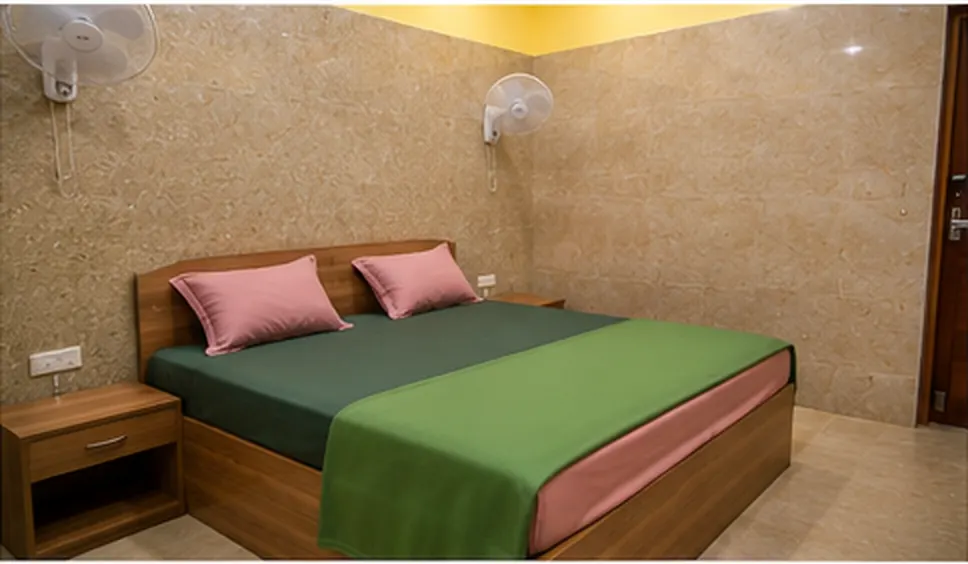 Non-AC Standard Room with queen bed and ceiling fan at AVS Guest House Puducherry